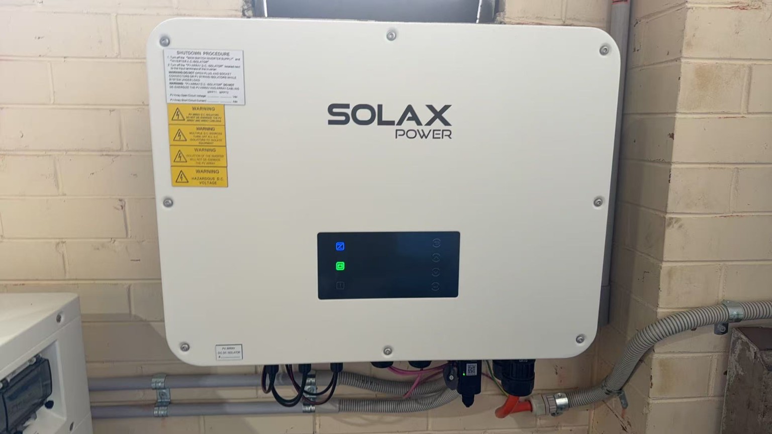 SolaX Power hybrid inverter installed on a wall